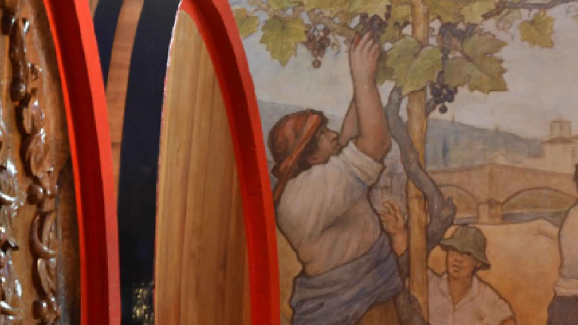 Ruffino 1877 wine cellar, showing a historic painting of a man picking grapes.