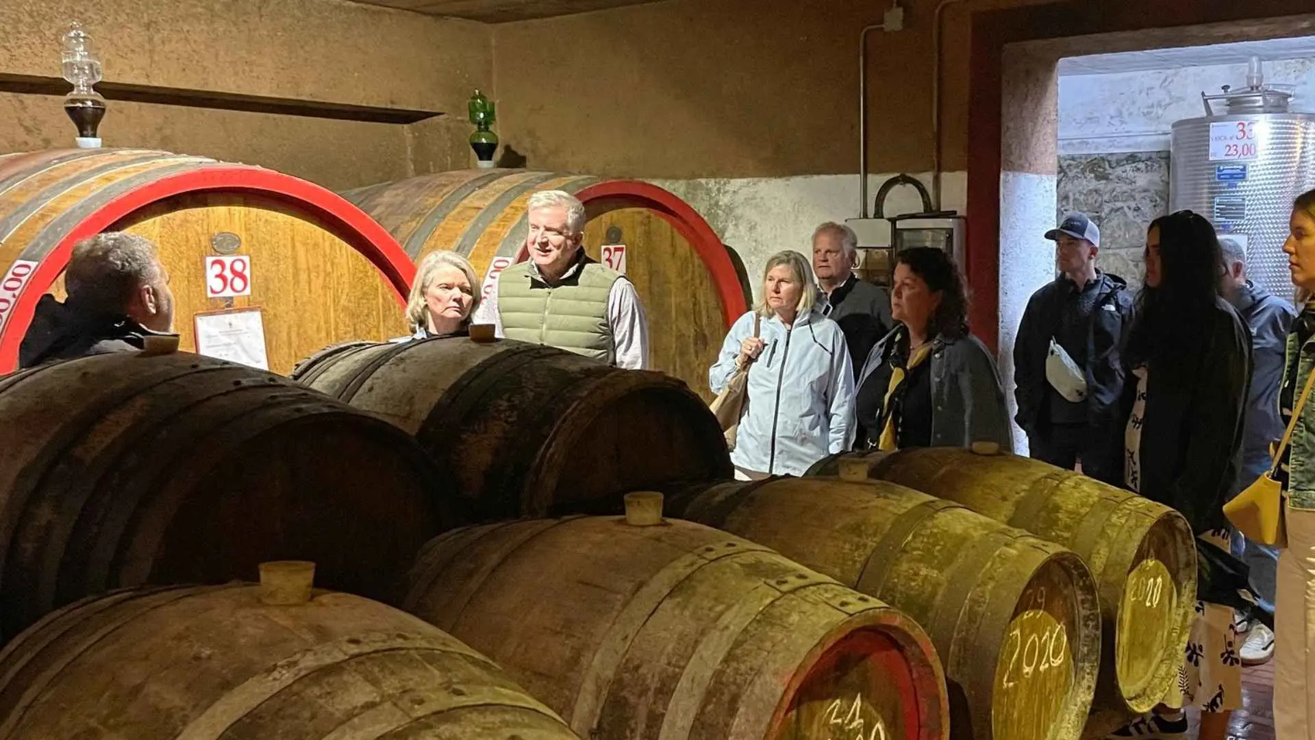 Casa Sola tour, showing tourists and a guide, in the wine cellar of the Casa Sola winery.