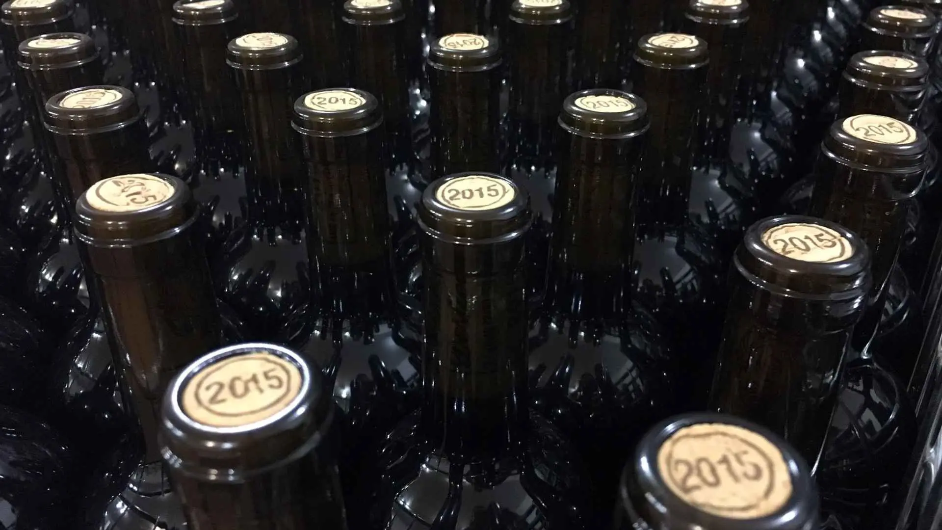 Château Destieux wine bottles, showing the very top of the bottle, with 2015 printed on each bottle.