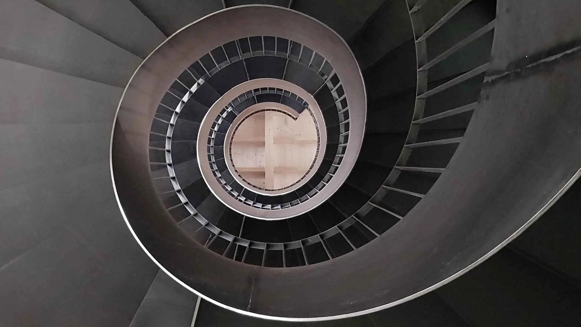 The image shows a winding staircase, taken from above, at the Conte Vistarino winery.