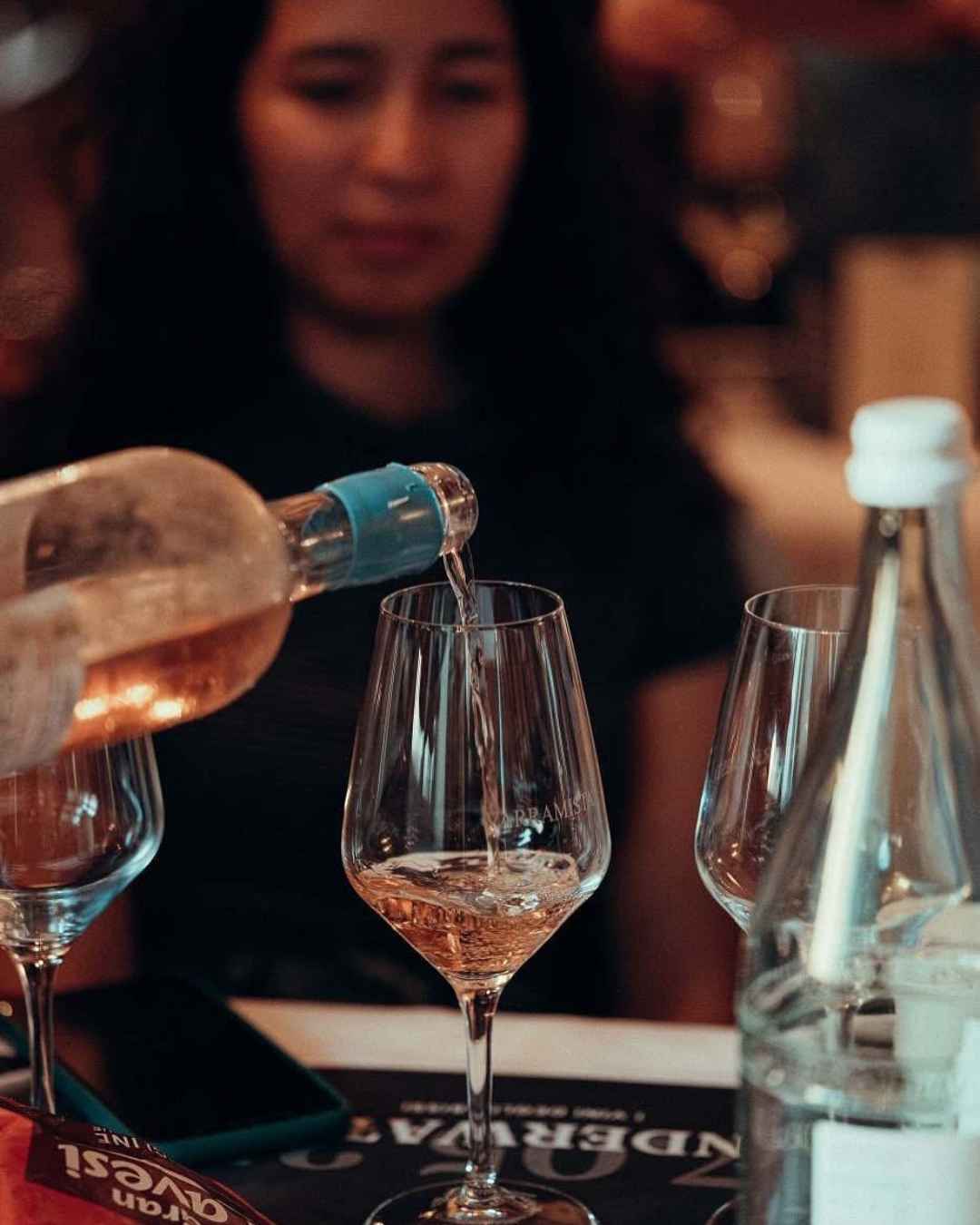Rose wine Rose wine being poured in a glass.